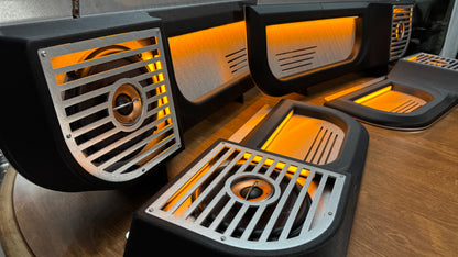 Set of BBOR V3 lighted Squarebody door speaker panels with brushed aluminum grilles and orange lighting